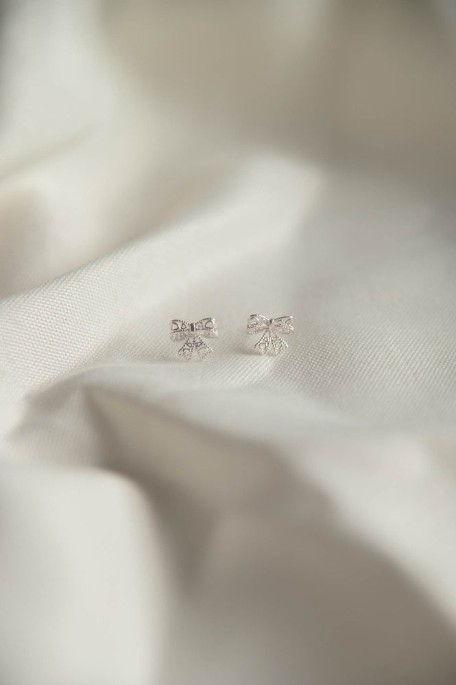 
            
                Load image into Gallery viewer, Carol Ribbon Studs in silver
            
        